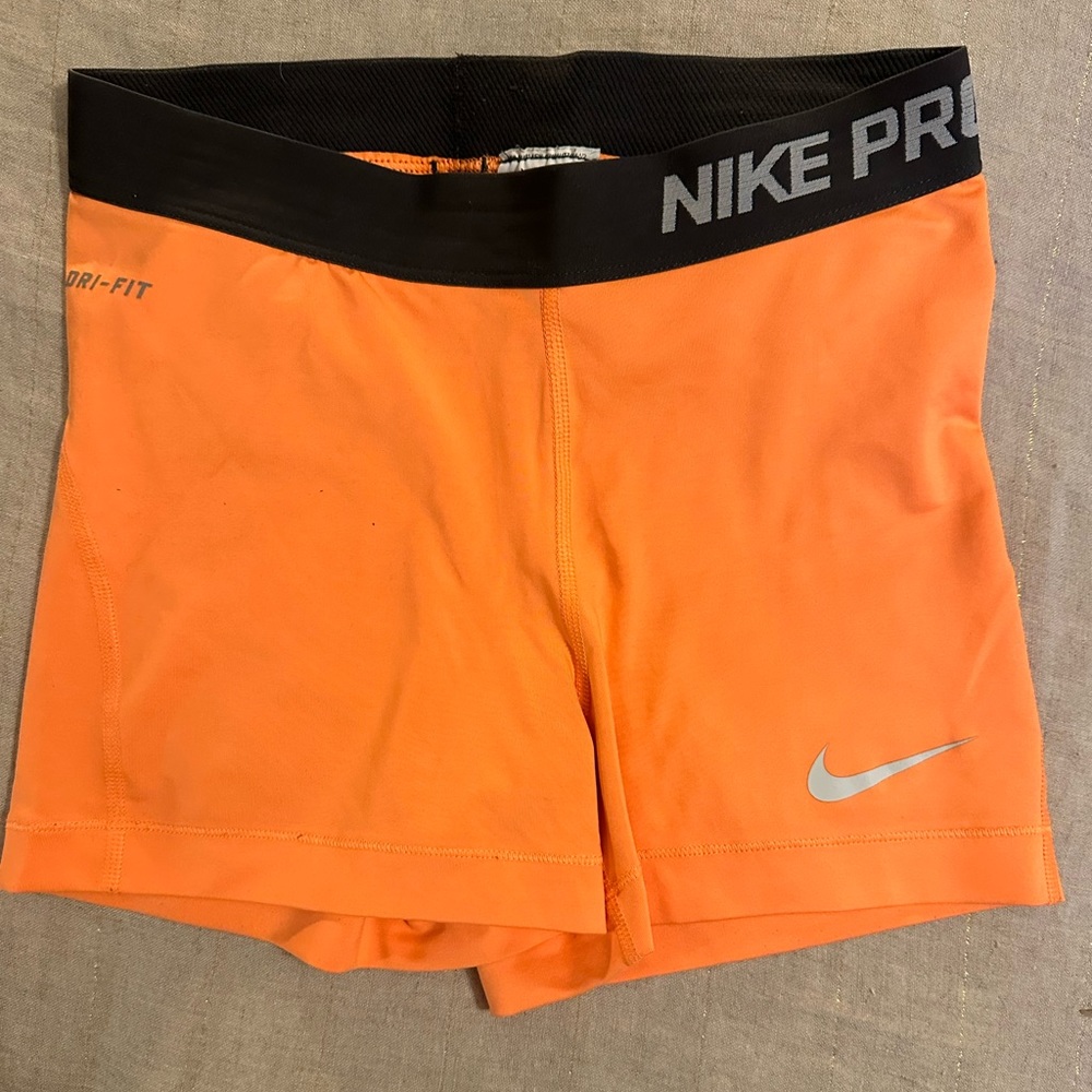 Bright orange Nike pro spandex. Size small, barely worn.